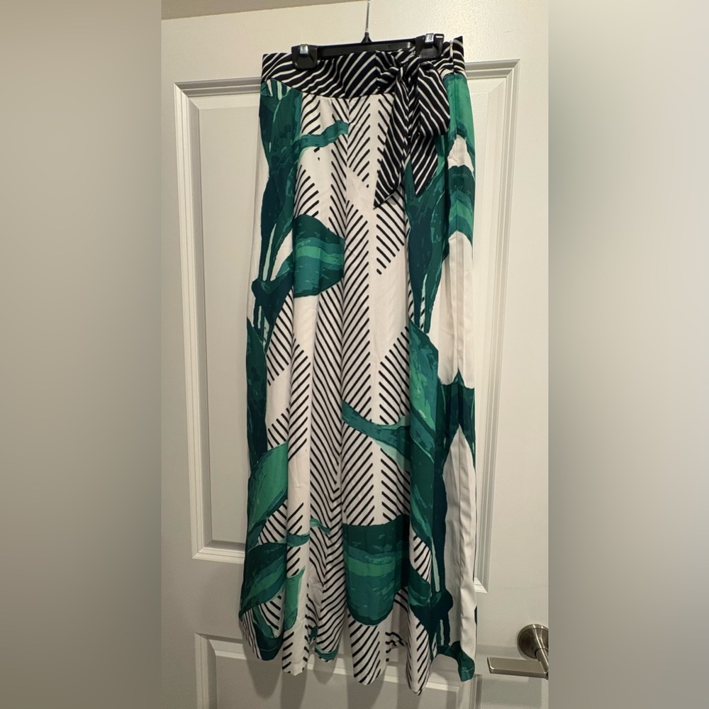 Green and black printed wide leg pants with tie detail at waist.